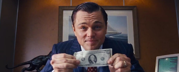Leonardo DiCaprio in the wolf of wall street holding a dollar bill