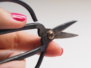 someone-cutting-the-cable-cord-with-pliers